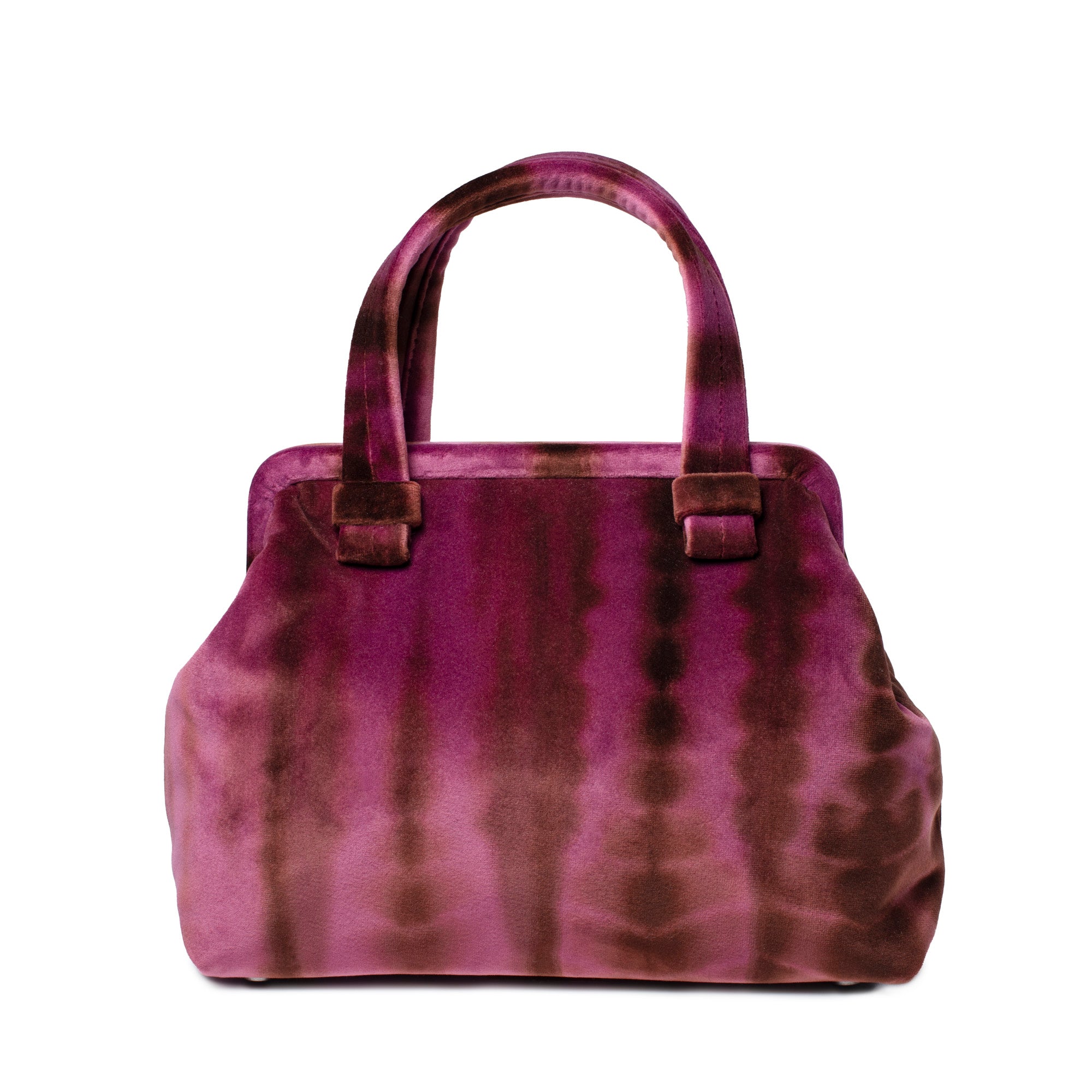 A structured handbag with a tie-dye pattern in shades of magenta, purple, and brown, featuring two top handles and small rectangular leather accents on the front, set against a plain white background.